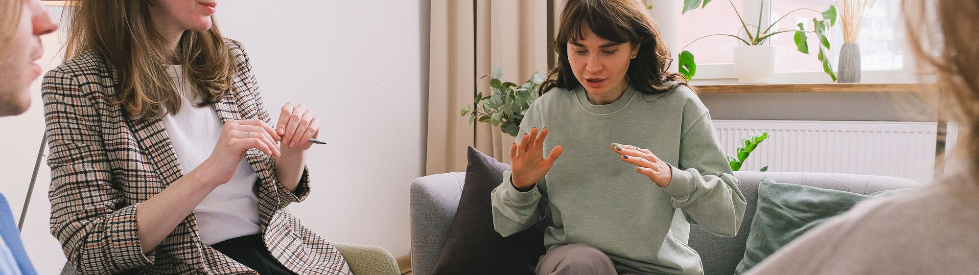A clinician in conversation in a calm, plant-filled room